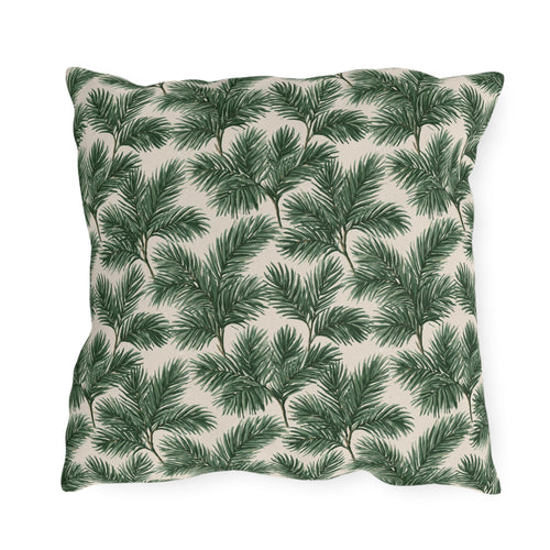 Deep green pine and fir branches on cream outdoor pillow
