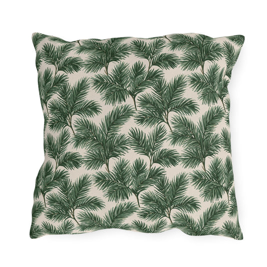 Deep green pine and fir branches on cream outdoor pillow
