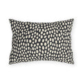 Hand-painted cream dots on charcoal outdoor lumbar pillow