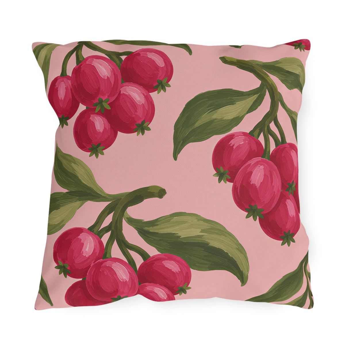 Pink outdoor pillow with painted raspberry red berry clusters and olive green leaves on blush