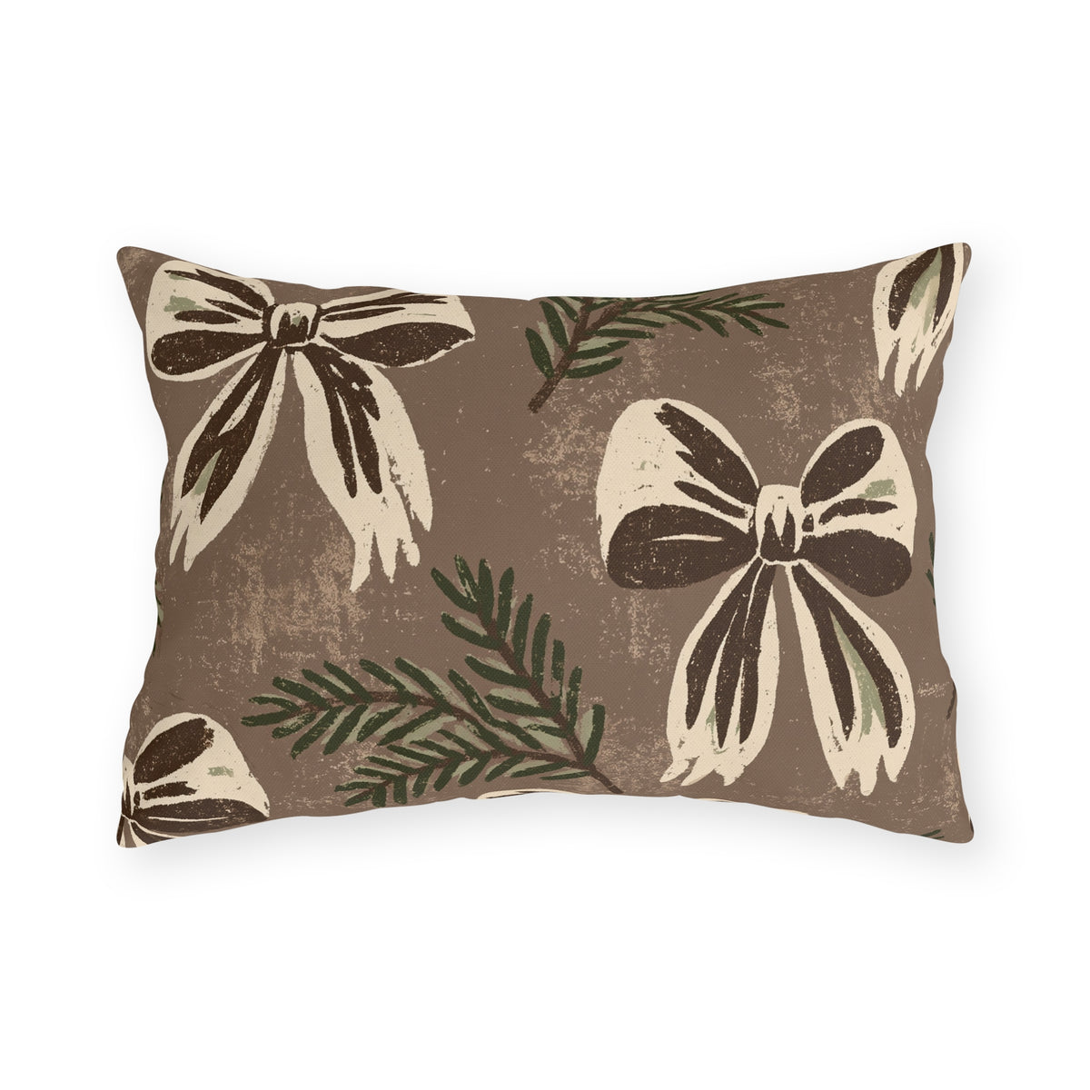 Cream and chocolate bows with spruce sprigs on a warm brown outdoor lumbar pillow