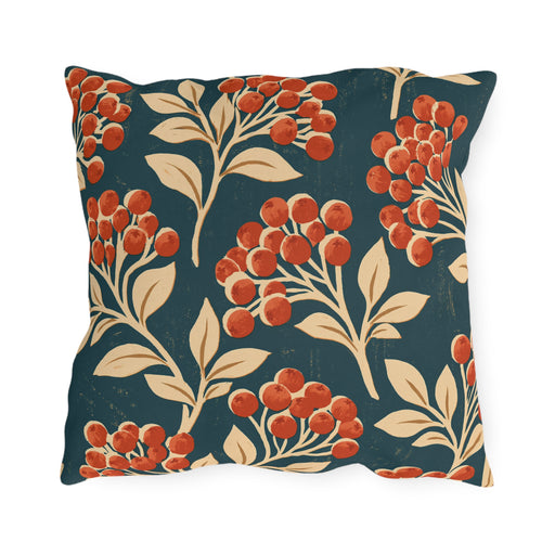 Red berry clusters with cream leaves on a deep teal outdoor pillow