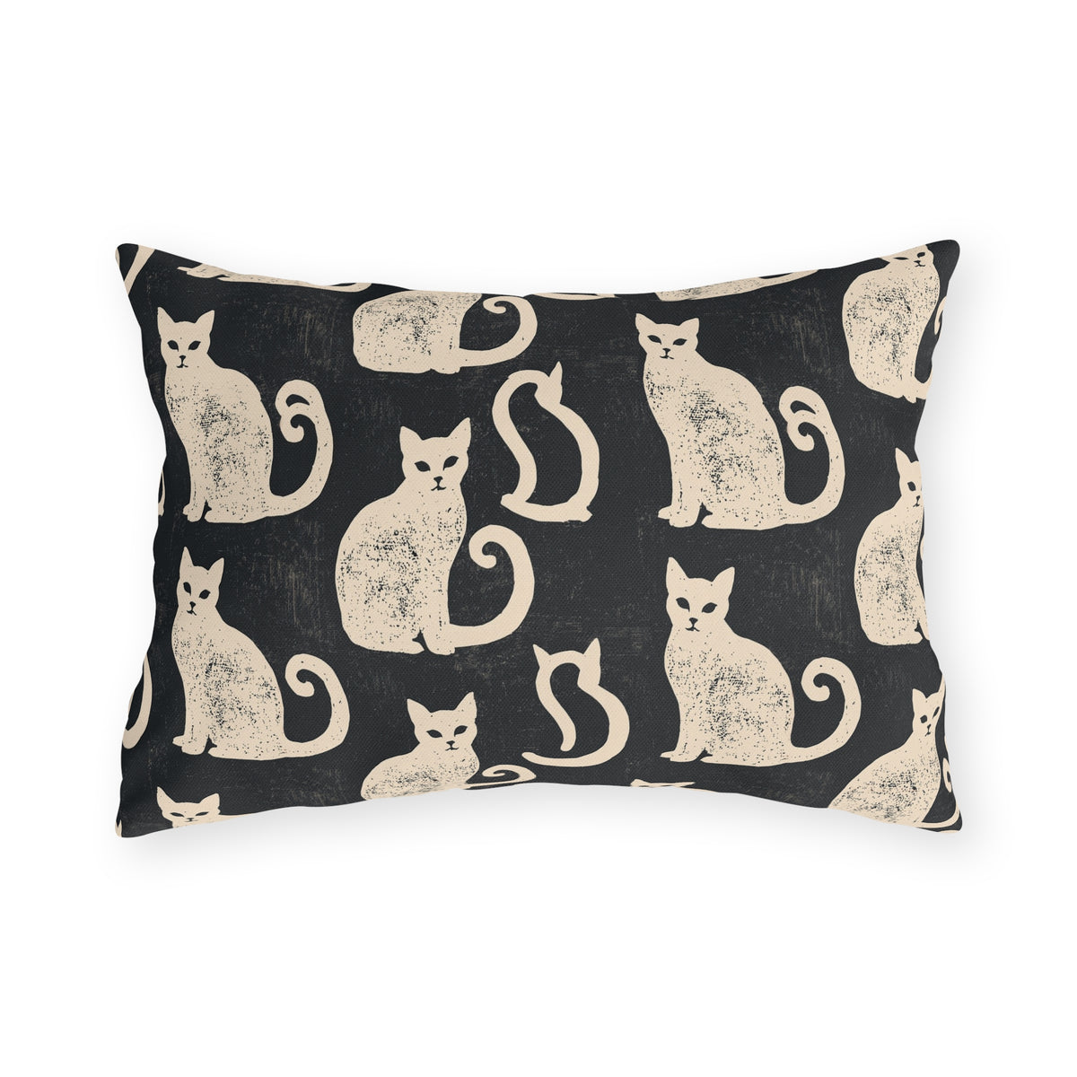 Cream folk art cats on a near-black outdoor lumbar pillow, worn block print