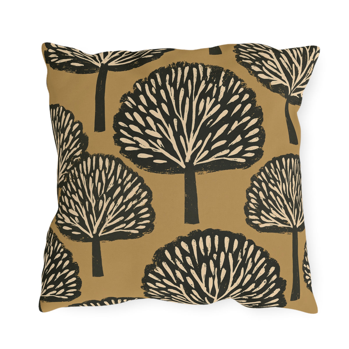 Black and cream block print trees on a warm ochre outdoor pillow