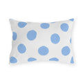 Light blue polka dot outdoor lumbar pillow with hand-painted powder blue dots on bright white