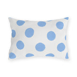 Light blue polka dot outdoor lumbar pillow with hand-painted powder blue dots on bright white