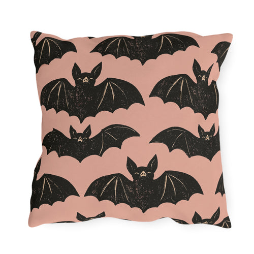 Black block print bats on a dusty blush outdoor pillow