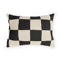 Black and cream checkerboard outdoor lumbar pillow with large hand-painted squares