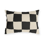 Black and cream checkerboard outdoor lumbar pillow with large hand-painted squares