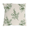 Green outdoor pillow with sage green eucalyptus sprigs tied with ribbon bows on cream