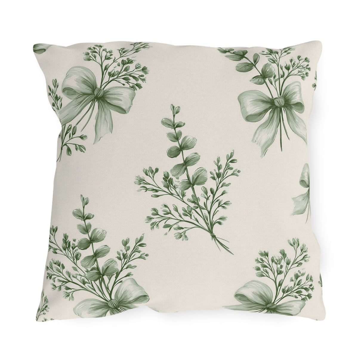 Green outdoor pillow with sage green eucalyptus sprigs tied with ribbon bows on cream