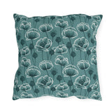 Teal and white poppies and seed heads on teal outdoor pillow