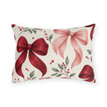 Winter outdoor lumbar pillow with watercolor red and pink satin bows, red berries and green leaves on cream