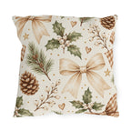 Christmas outdoor pillow with watercolor pinecones, holly with white berries, pine sprigs and ribbon bows on cream