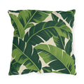 Tropical outdoor pillow with large overlapping fresh and deep green banana leaves on cream