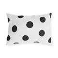 Black and white polka dot outdoor lumbar pillow with large hand-painted charcoal dots on warm white