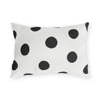 Black and white polka dot outdoor lumbar pillow with large hand-painted charcoal dots on warm white
