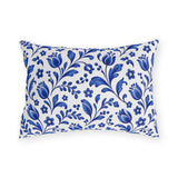 Scattered cobalt blue tulips and vines on a white outdoor lumbar pillow
