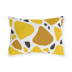 Yellow terrazzo outdoor lumbar pillow with large yellow and ochre stones and charcoal chips on white