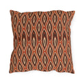 Nested ikat diamonds in charcoal and cream on a burnt rust outdoor pillow