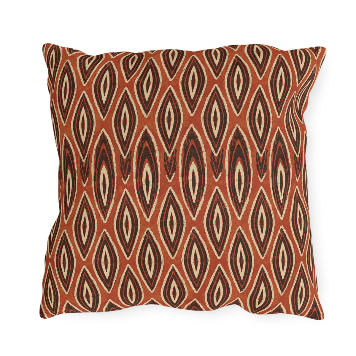 Nested ikat diamonds in charcoal and cream on a burnt rust outdoor pillow