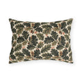 Deep green oak leaves and acorns on cream outdoor lumbar pillow