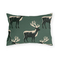 Black and cream block print stags on a deep forest green outdoor lumbar pillow