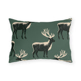 Black and cream block print stags on a deep forest green outdoor lumbar pillow