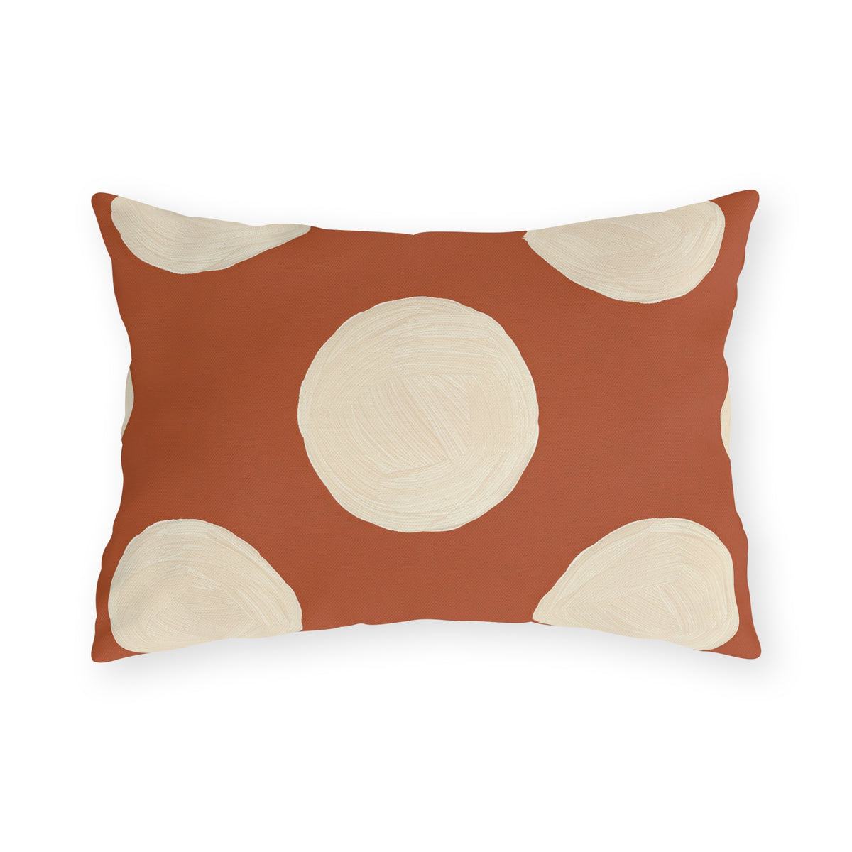 Modern polka dot outdoor lumbar pillow with large hand painted cream dots on terracotta orange