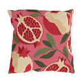 Modern outdoor pillow with cream and red pomegranates and green leaves on bright pink