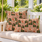 Blush flamingo arches outdoor pillow and outdoor lumbar pillow styled together as a set on a porch swing