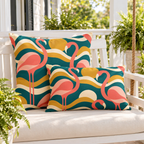 Teal retro flamingo outdoor pillow and outdoor lumbar pillow styled together as a set on a porch swing