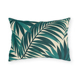 Tropical outdoor lumbar pillow with large overlapping teal palm fronds on cream