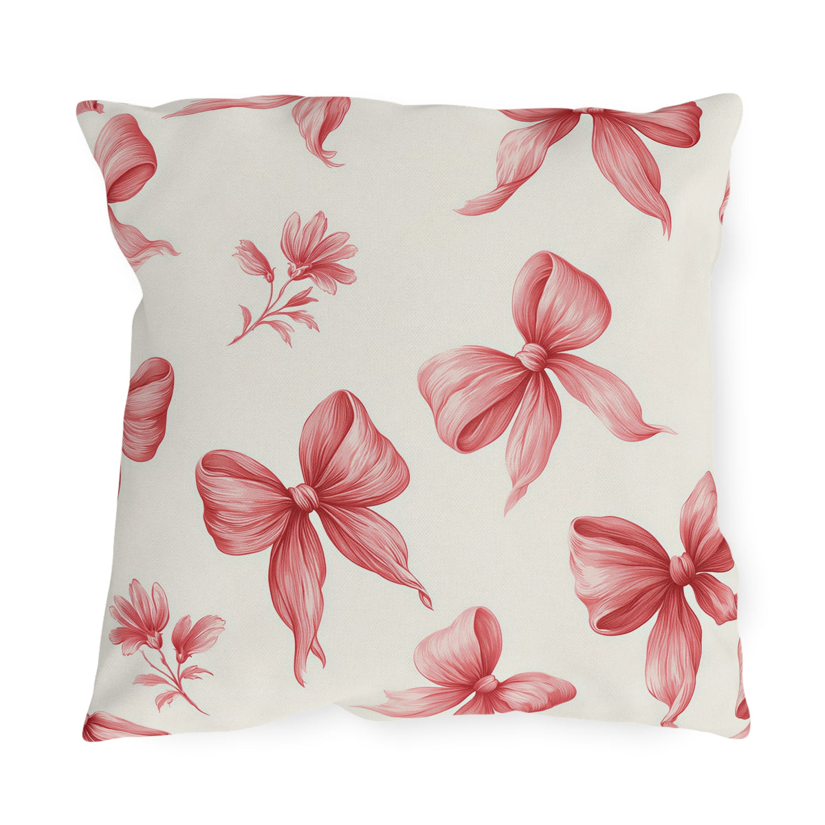 Pink outdoor pillow with hand-drawn rose pink ribbon bows and small flower sprigs on cream