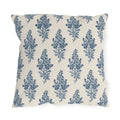 Blue engraved blossom sprigs on a cream outdoor pillow