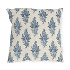 Blue engraved blossom sprigs on a cream outdoor pillow