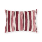 Cranberry and rose painted stripes on a cream outdoor lumbar pillow
