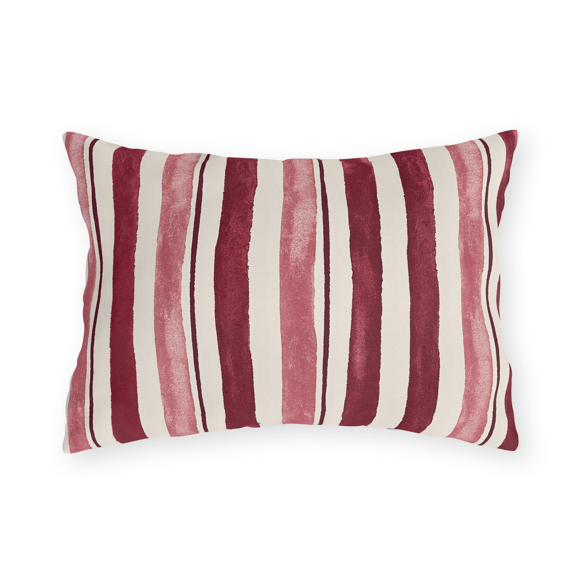 Cranberry and rose painted stripes on a cream outdoor lumbar pillow