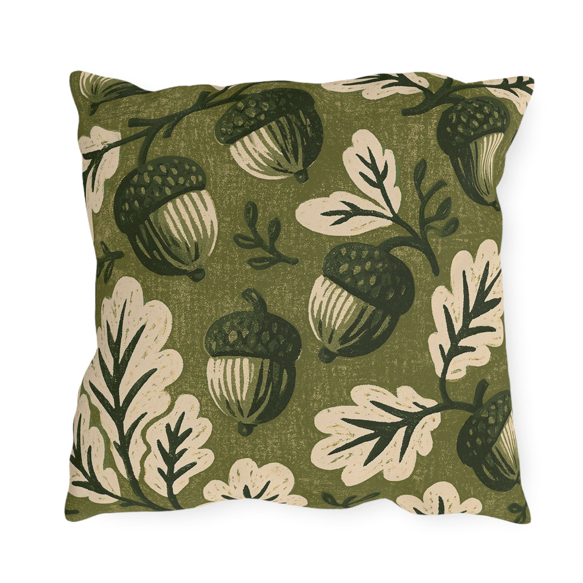 Acorns and oak leaves in forest green and cream on a mossy olive outdoor pillow