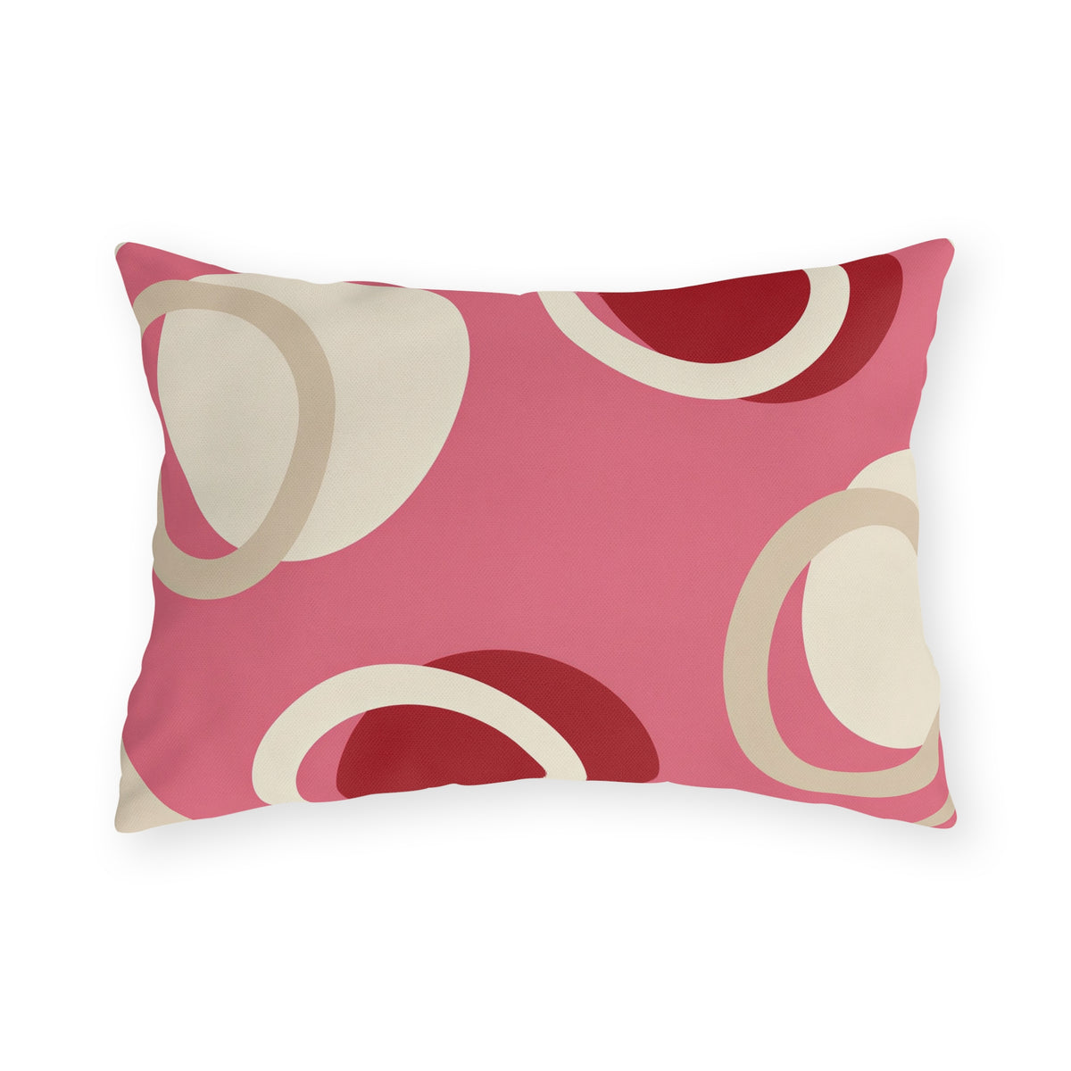Modern outdoor lumbar pillow with overlapping cream rings and cherry red circles on bright pink