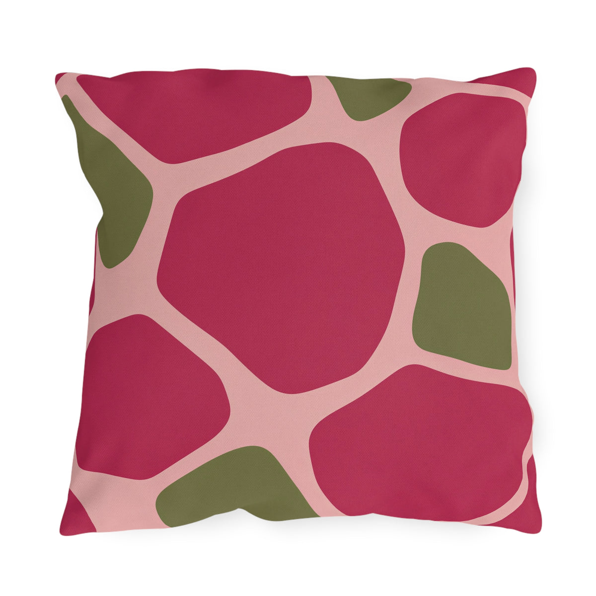 Modern outdoor pillow with large raspberry pink and olive green pebble shapes on blush