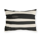 Wide black brushed stripes on a cream outdoor lumbar pillow