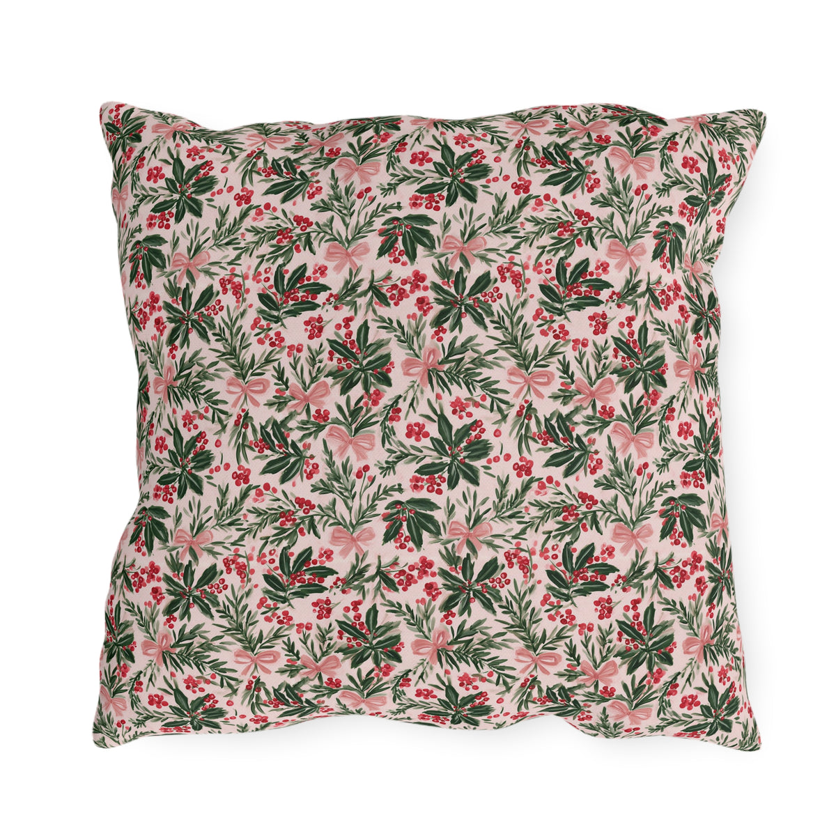 Holly, pine, red berries and pink bows on blush outdoor pillow