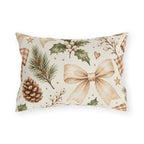 Christmas outdoor lumbar pillow with watercolor pinecones, holly with white berries, pine sprigs and ribbon bows on cream