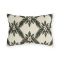 Pine sprays and white berry clusters in a symmetrical lattice on a cream outdoor lumbar pillow