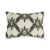 Pine sprays and white berry clusters in a symmetrical lattice on a cream outdoor lumbar pillow
