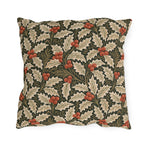 Ivory and olive holly leaves with coral berries on a deep green outdoor pillow