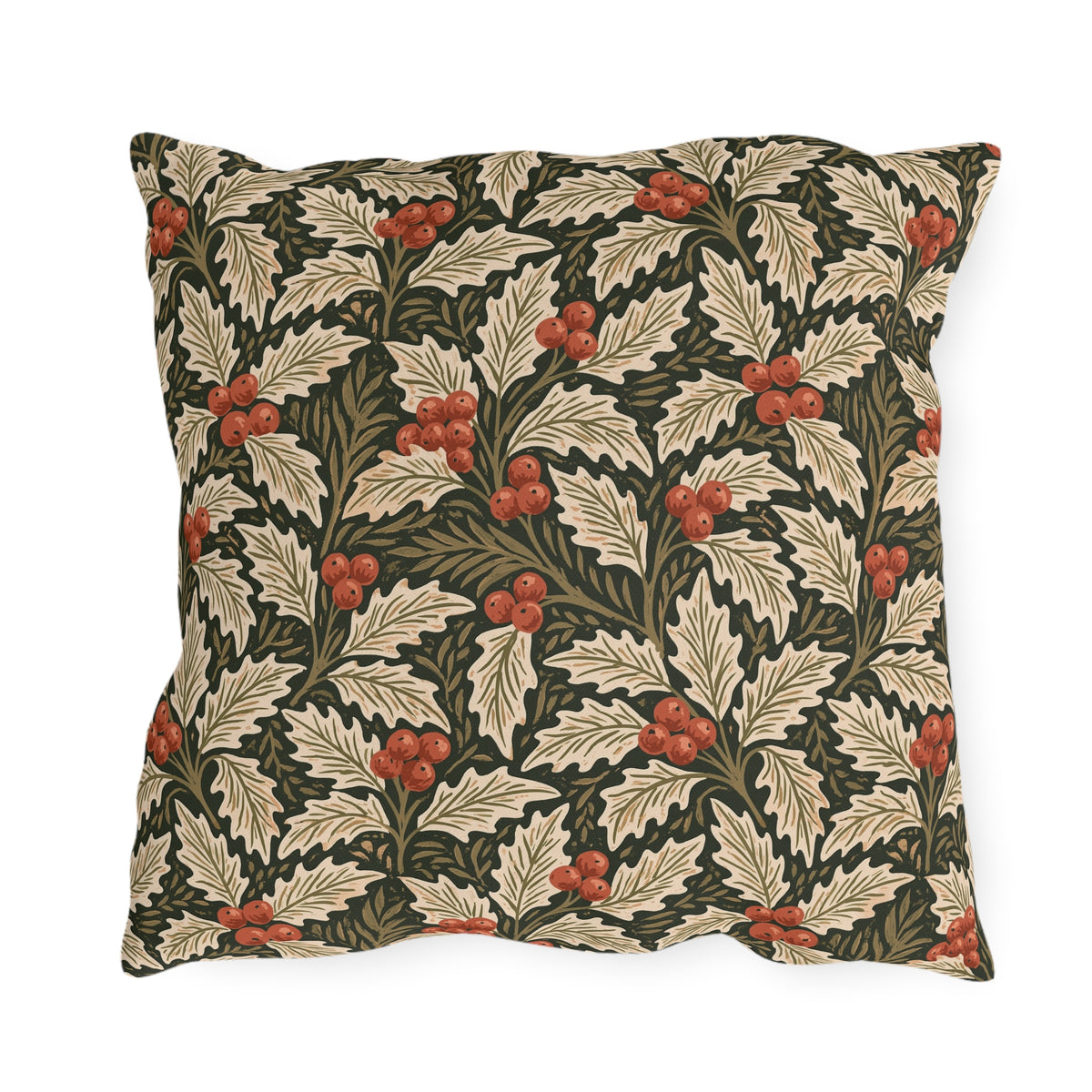 Ivory and olive holly leaves with coral berries on a deep green outdoor pillow