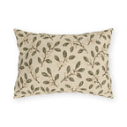 Olive leaves and pale snowberries block printed on a cream outdoor lumbar pillow