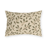 Olive leaves and pale snowberries block printed on a cream outdoor lumbar pillow